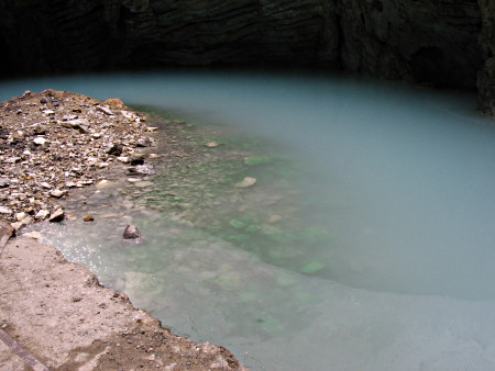 A large natural well of peculiarly looking whitish water.