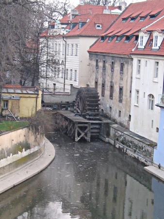 A water whell of a mill in a channel of the Vltava river.
