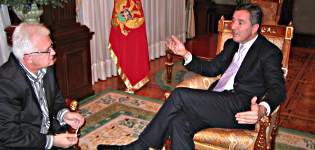 Milo &#272;ukanovi&#263; sitting on a chair answering an interview.