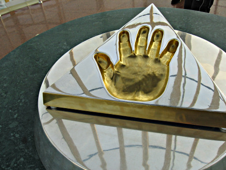 A shiny metal imprint of a hand.