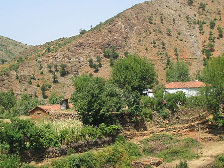 Two simple houses in a mountainous area.