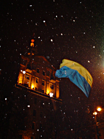 Ukrainian flag waves in a snowy night.
