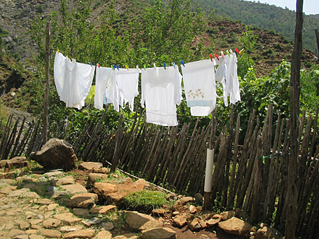 Traditional women gowns are drying in a courtyard. 