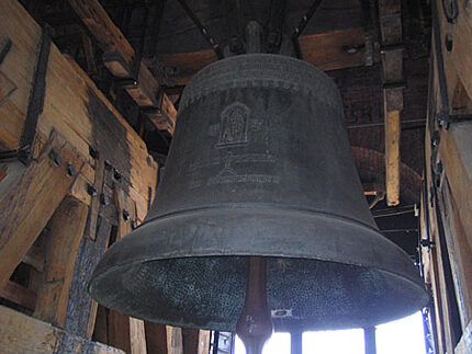 A very big bell in a wooden structure